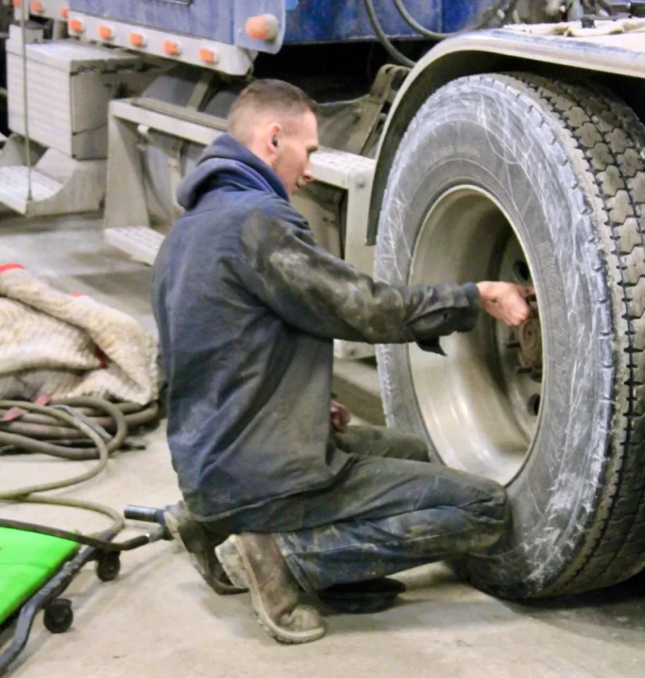 Cessna Transport mechanic working on a truck wheel.